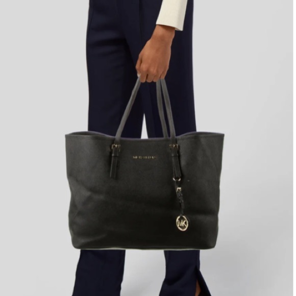 Black leather Michael Kors tote bag with gold-toned accents and flat handles. - Picture 2 of 12